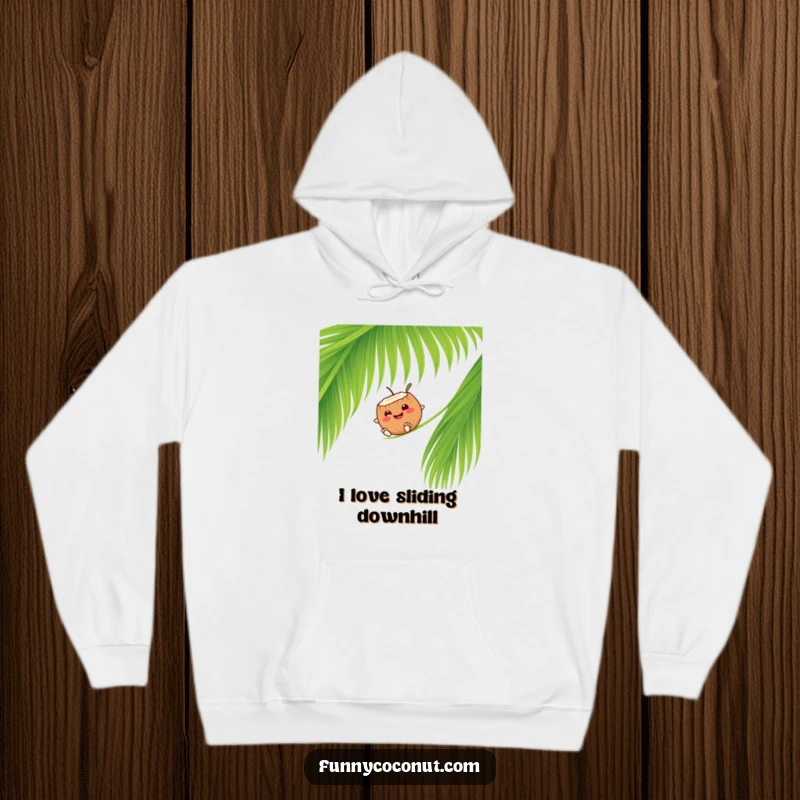 Funny smiling coconut character sliding down a palm frond, a warm and comfy hoodie for cool evenings.