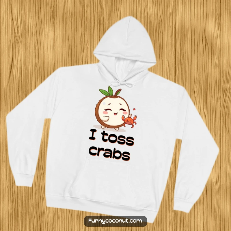 Funny Kawaii Coconut Hoodie: a cute character winking while tossing a tiny crab, perfect for cozy beach vibes and playful mischief.